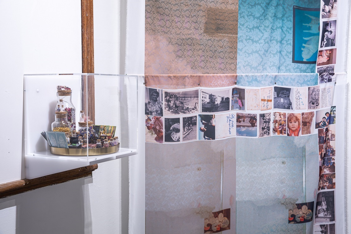 Close-up of artwork including printed fabric and small display case