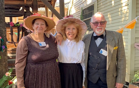 Three volunteers dressed in old-style clothing in FCMG Vintage Village