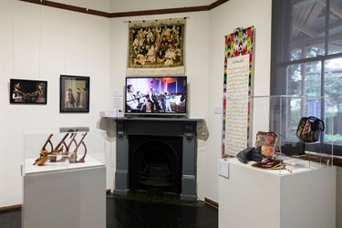 Museum display showing various traditional Uyghur cultural objects