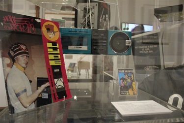 Museum display showing HYPE magazine, a blue cassette player and a cassette tape by Sounds Unlimited