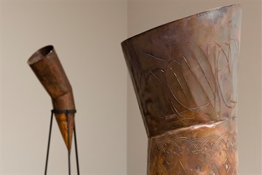 Close up of cone shaped copper sculptures on stands
